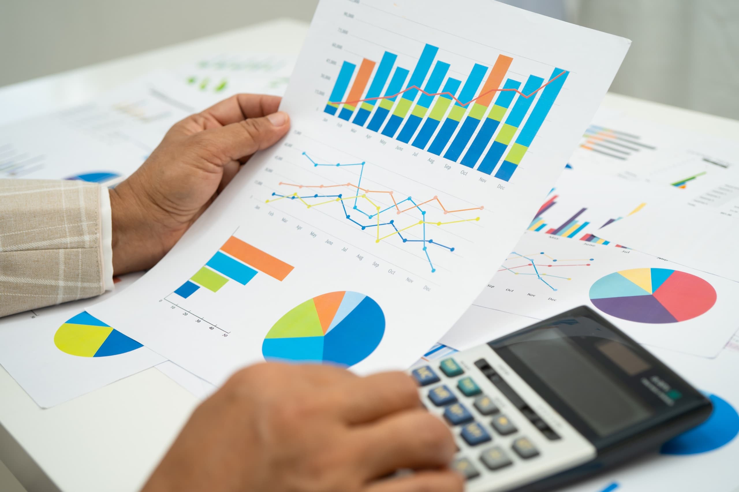 Business woman analyzing financial graphs and reports