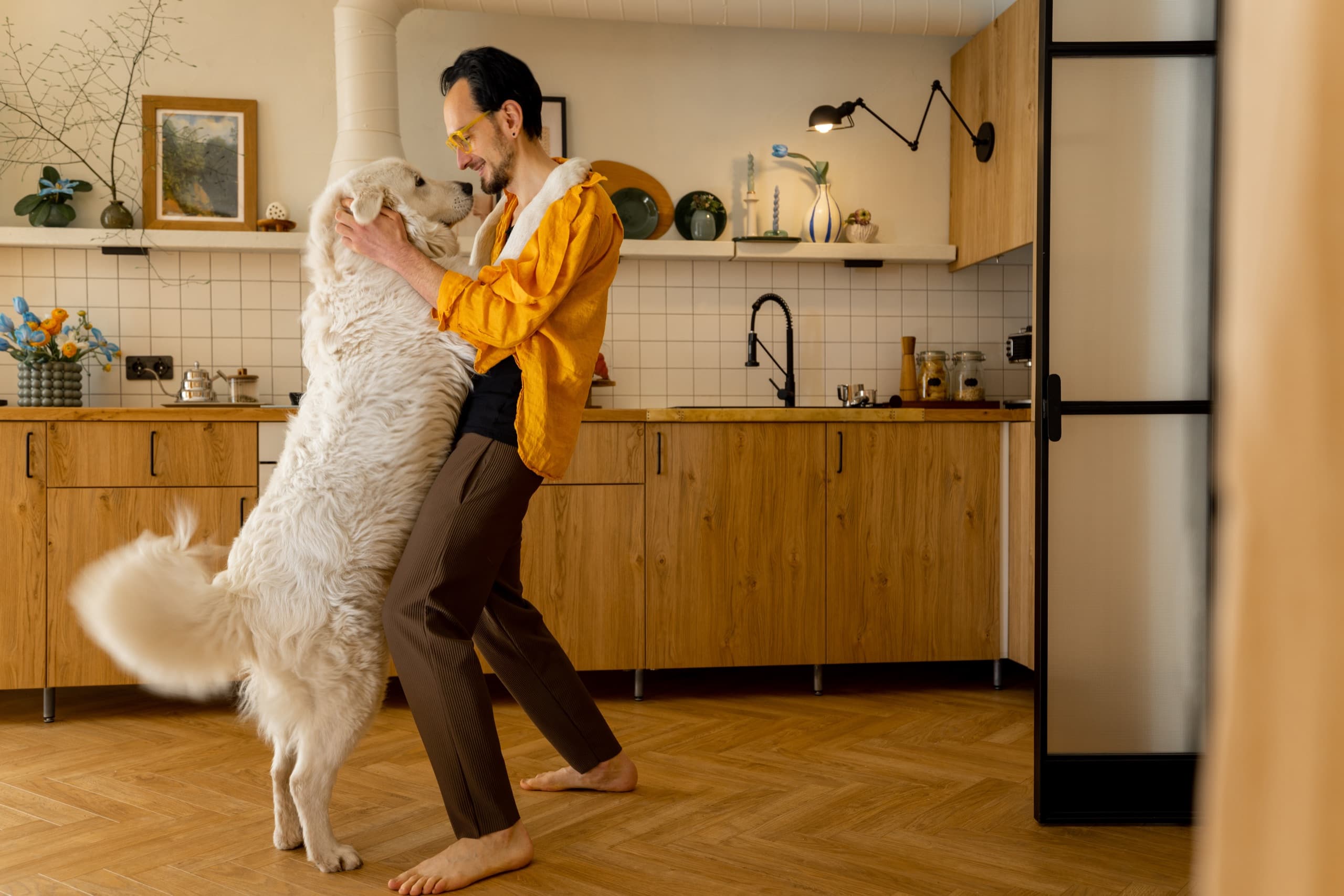 Man with dog in kitchen