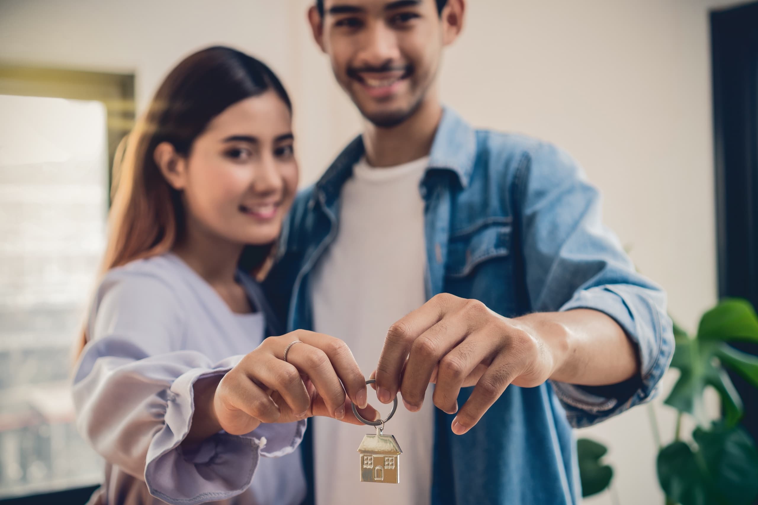 Hand holding house keys for a self-guided tour
