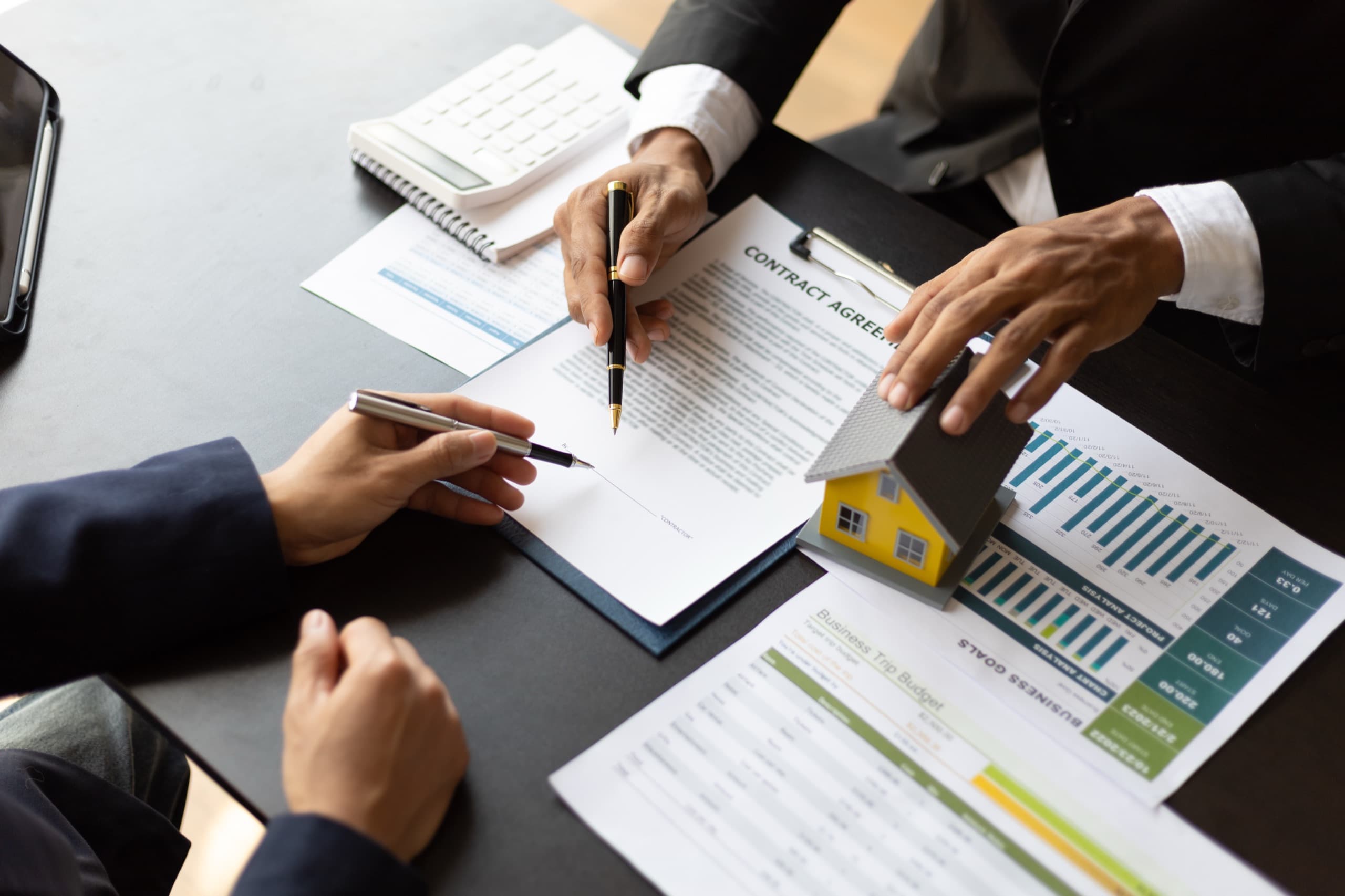 Real estate professionals reviewing property market data