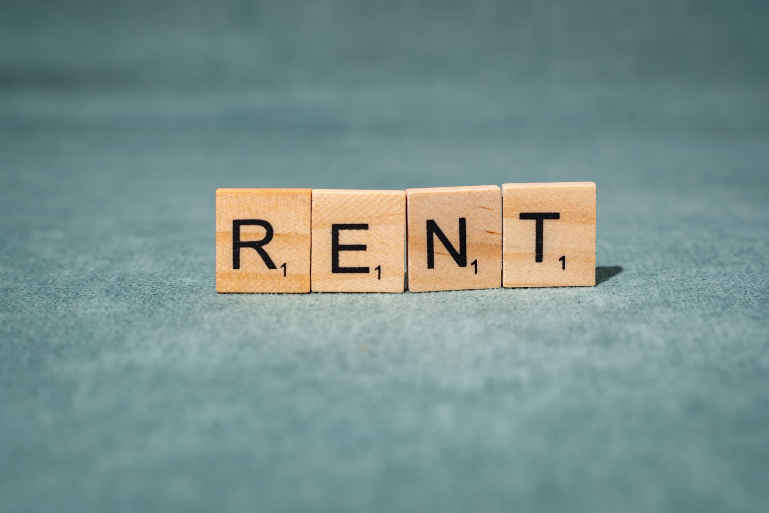 Wooden letters spelling rent