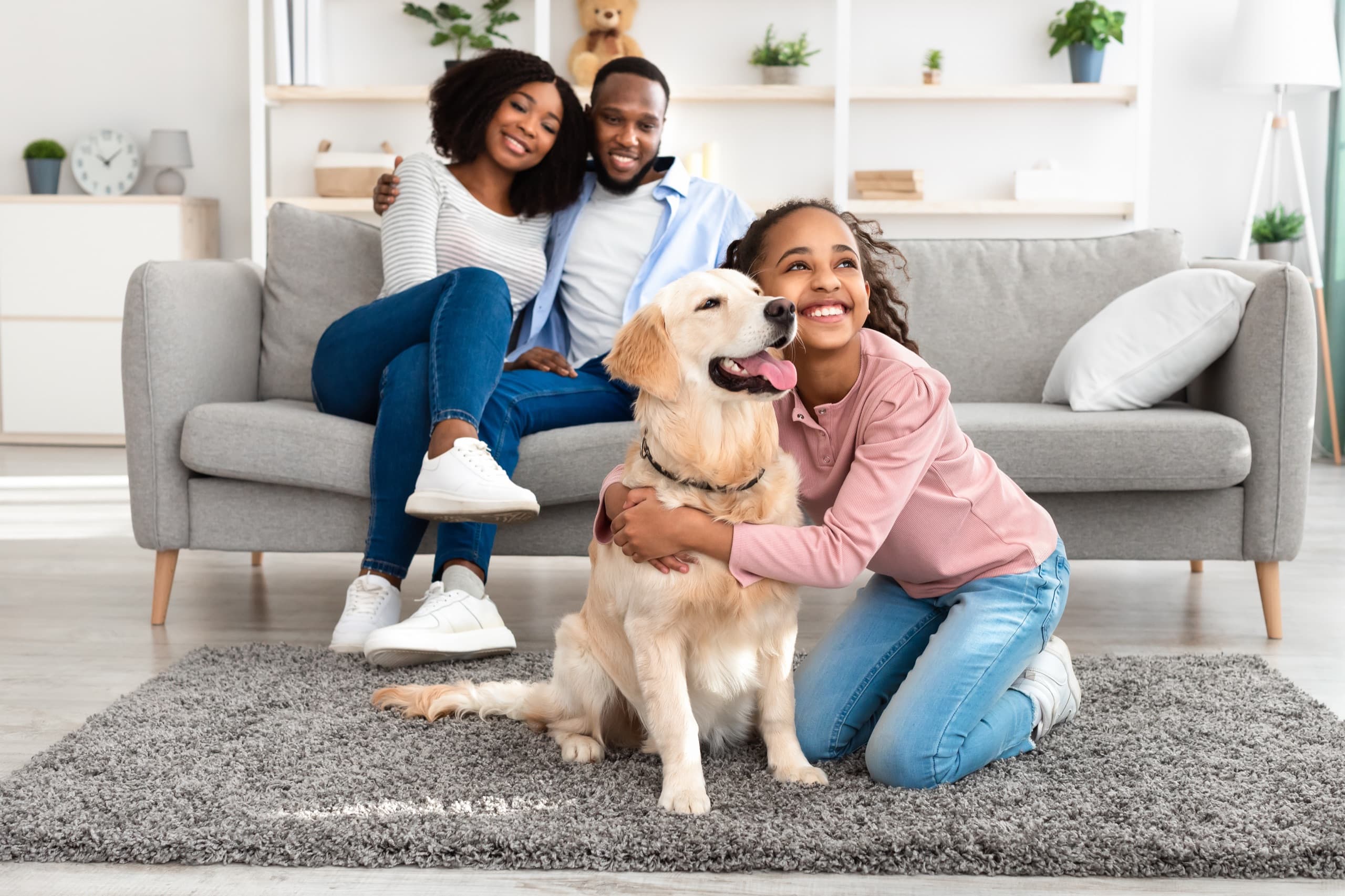 Young girl hugging dog at home